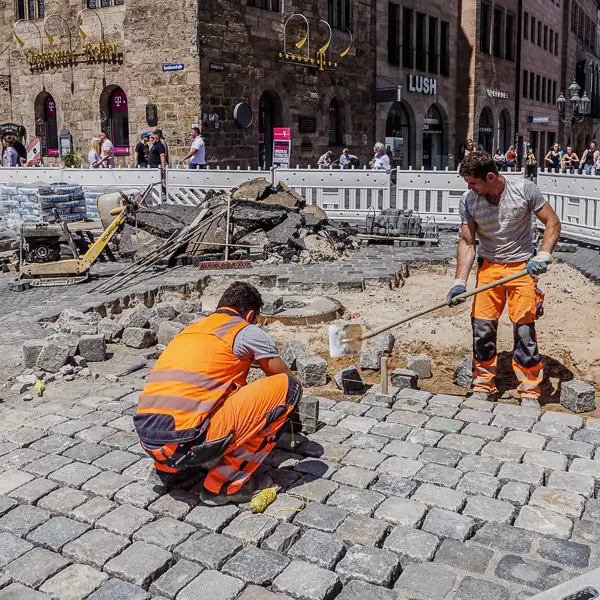 Workers replace paving stones in Nuremberg, Germany.